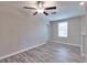 Bedroom with hard surface floors and a ceiling fan at 16719 Delia St, Wimauma, FL 33598