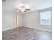 Spacious bedroom with gray wood-look flooring and a scenic window at 16719 Delia St, Wimauma, FL 33598