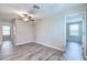 Bedroom with hard surface floors, ceiling fan, and two windows at 16719 Delia St, Wimauma, FL 33598
