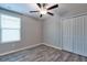 Cozy bedroom with hard surface floors and a double door closet at 16719 Delia St, Wimauma, FL 33598