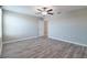 An open bedroom with wood-look flooring and neutral paint at 16719 Delia St, Wimauma, FL 33598
