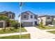 Charming two-story home with a well-manicured lawn and a two-car garage at 16719 Delia St, Wimauma, FL 33598