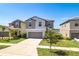 Attractive two-story home with a well-maintained lawn and a two-car garage at 16719 Delia St, Wimauma, FL 33598