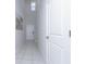 Bright hallway with tiled floors and a small window near the staircase at 16719 Delia St, Wimauma, FL 33598