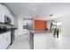 Open kitchen with granite countertops, stainless steel appliances and adjacent dining area at 16719 Delia St, Wimauma, FL 33598