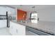 Open kitchen with granite countertops, stainless steel appliances, and adjacent dining area at 16719 Delia St, Wimauma, FL 33598