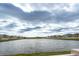 Scenic pond view surrounded by homes in a quiet neighborhood under a cloudy sky at 16719 Delia St, Wimauma, FL 33598