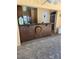Covered outdoor patio bar featuring brick floors, stained wood, and access to an outdoor restroom at 2280 Toniwood Ln, Palm Harbor, FL 34685