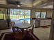 Bright dining area featuring views of the pool and backyard, seamlessly connected to the kitchen at 2280 Toniwood Ln, Palm Harbor, FL 34685