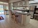 Bright kitchen featuring a breakfast bar with seating, white cabinets, and stainless steel appliances at 2280 Toniwood Ln, Palm Harbor, FL 34685
