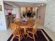 Cozy living area flows to dining and kitchen area with an inviting fireplace and comfortable seating at 2280 Toniwood Ln, Palm Harbor, FL 34685