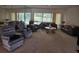 Bright living room with views of the pool, featuring ample seating and natural light at 2280 Toniwood Ln, Palm Harbor, FL 34685