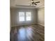 Bedroom featuring hardwood floors, neutral paint and multiple windows providing ample natural light at 2588 Bartolo Dr, Land O Lakes, FL 34639