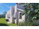 View of the home's exterior showcasing its unique stucco finish, trimmed windows, and lush foliage at 509 Rosery Nw Rd, Largo, FL 33770