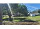 Exterior view of the property showcasing its large lot and mature trees at 509 Rosery Nw Rd, Largo, FL 33770