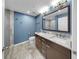 A full bathroom with double sinks, granite countertops, and ample lighting at 700 S Harbour Island Blvd # 226, Tampa, FL 33602