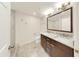Bright bathroom with double vanity featuring granite counters, decorative mirror, and tiled flooring at 700 S Harbour Island Blvd # 226, Tampa, FL 33602