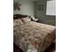 Cozy bedroom features a large bed with floral bedding and a starfish wall decoration at 1819 Shore S Dr # 203, South Pasadena, FL 33707