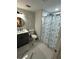 Stylish bathroom featuring a vanity with sink, toilet, and a shower with decorative curtains at 6220 Westport Dr, Port Richey, FL 34668