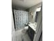 Bathroom features a marine-themed shower curtain and updated fixtures at 6220 Westport Dr, Port Richey, FL 34668