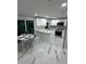 Bright kitchen with white cabinetry, modern appliances, and a dining area at 6220 Westport Dr, Port Richey, FL 34668