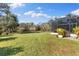 Expansive backyard with lush green lawn and screened in porch at 7876 Marsh Pointe Dr, Tampa, FL 33635