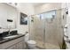 Updated bathroom with a glass-enclosed shower, granite countertop, and modern fixtures at 7876 Marsh Pointe Dr, Tampa, FL 33635