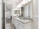 Bathroom features a double sink vanity, granite countertops, and framed mirrors at 7876 Marsh Pointe Dr, Tampa, FL 33635