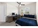 Comfortable bedroom with a bed, desk, chair, and natural light from a window at 7876 Marsh Pointe Dr, Tampa, FL 33635