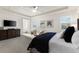 Spacious bedroom boasts tray ceiling, two windows, dark wood dresser, and seating area at 7876 Marsh Pointe Dr, Tampa, FL 33635