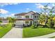 Stunning home with lush lawn, stone accents, and paver driveway at 7876 Marsh Pointe Dr, Tampa, FL 33635