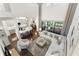 Sun-filled living room showcases soaring ceilings, an oversized sofa, and an open-concept kitchen at 7876 Marsh Pointe Dr, Tampa, FL 33635