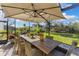 Outdoor patio with dining table, umbrella, and views of the backyard at 7876 Marsh Pointe Dr, Tampa, FL 33635