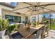 Outdoor patio with dining table, umbrella, and views of the backyard at 7876 Marsh Pointe Dr, Tampa, FL 33635