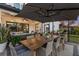 Cozy patio with umbrella, wooden table, and chairs for outdoor dining at 7876 Marsh Pointe Dr, Tampa, FL 33635