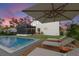 Backyard pool with lounge chairs, an umbrella, and a screened-in patio creates the perfect outdoor retreat at 7876 Marsh Pointe Dr, Tampa, FL 33635