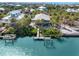 Stunning aerial view of a coastal home with a private dock and boat lift on tranquil blue waters at 79 Palm Dr, Placida, FL 33946