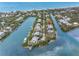Idyllic aerial view capturing waterfront homes nestled along winding canals and lush tropical landscapes at 79 Palm Dr, Placida, FL 33946