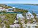 Breathtaking aerial view showcasing a waterfront home surrounded by lush tropical foliage and serene canals at 79 Palm Dr, Placida, FL 33946