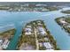 Panoramic aerial perspective of an island neighborhood featuring beautiful homes and winding canals at 79 Palm Dr, Placida, FL 33946