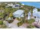 Stunning aerial view of a waterfront home with lush tropical landscaping and a private dock with bay access at 79 Palm Dr, Placida, FL 33946