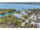 Waterfront property with multiple homes, lush tropical landscaping, private docks, and serene canal views at 79 Palm Dr, Placida, FL 33946