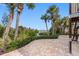 Private backyard with a brick paver patio, lush landscaping, and a waterfront view at 79 Palm Dr, Placida, FL 33946
