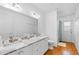 Modern bathroom featuring double sinks, granite countertop, and tile flooring at 79 Palm Dr, Placida, FL 33946