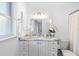 Bright bathroom with a marble countertop vanity, custom cabinetry, and decorative lighting at 79 Palm Dr, Placida, FL 33946