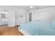 A bright bedroom with a queen bed, a ceiling fan, hardwood floors, and a private ensuite bathroom at 79 Palm Dr, Placida, FL 33946