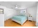 Bright bedroom featuring hardwood floors, closet, and bright windows at 79 Palm Dr, Placida, FL 33946