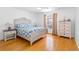 Bedroom with light hardwood floors, a ceiling fan, a double-hung window, and side tables at 79 Palm Dr, Placida, FL 33946