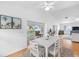 Bright dining room featuring vaulted ceilings, a ceiling fan, and sliding glass doors to the lanai at 79 Palm Dr, Placida, FL 33946