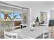 Dining area featuring views of the water, sliding doors to porch, and elegant white table set at 79 Palm Dr, Placida, FL 33946